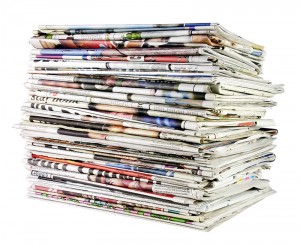 large stack of folded newspapers ready for recycling